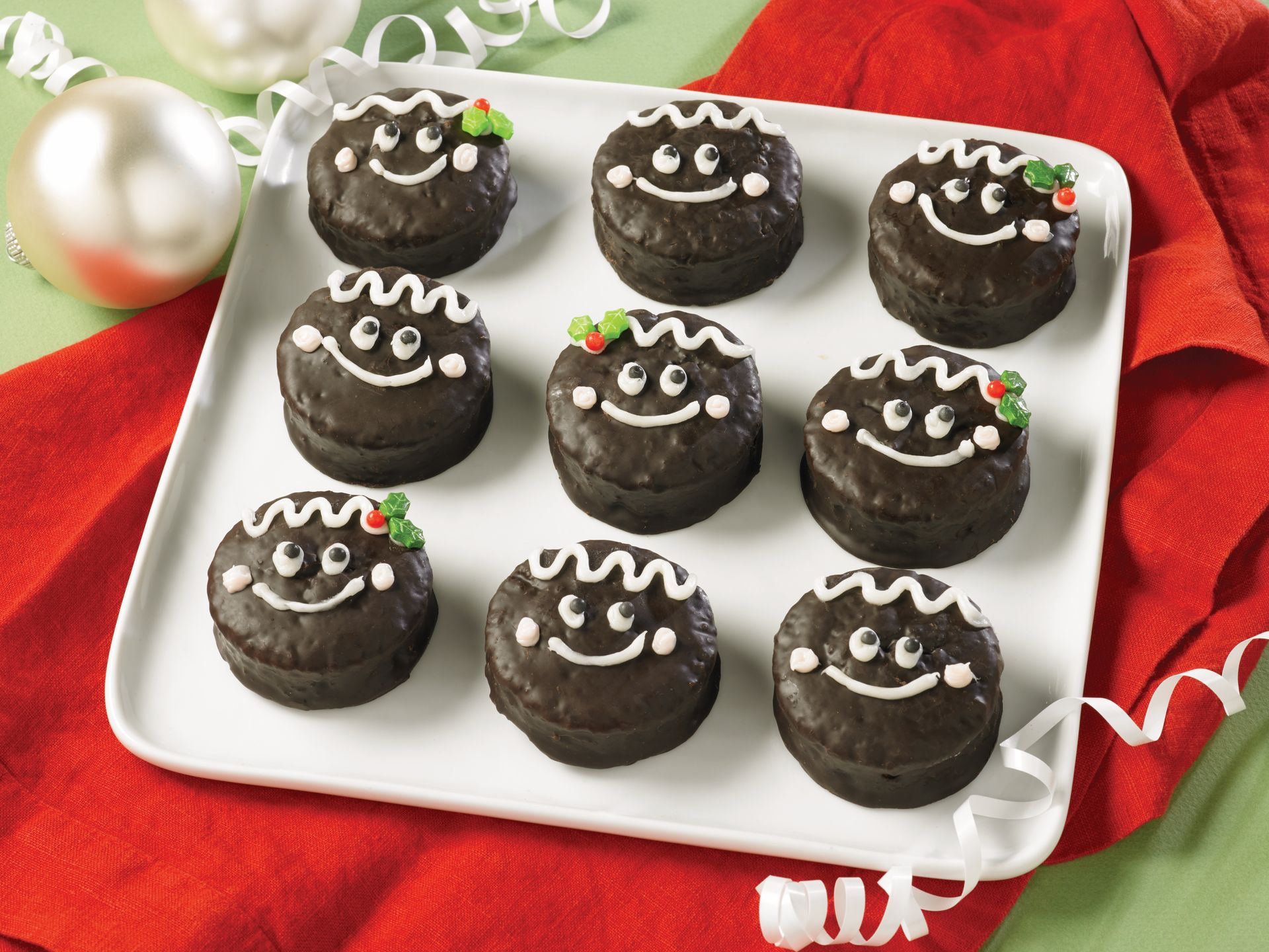 a plate of ring dings with gingerbread smiling faces