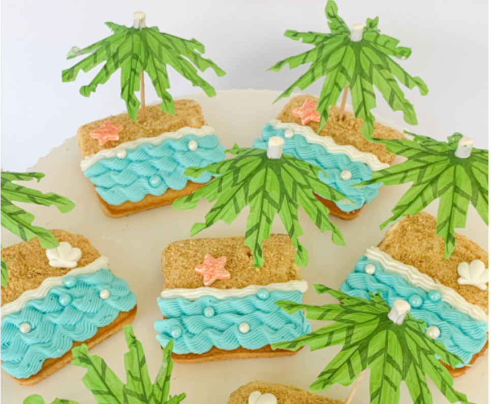 A table topped with cookies decorated to look like a tropical island.