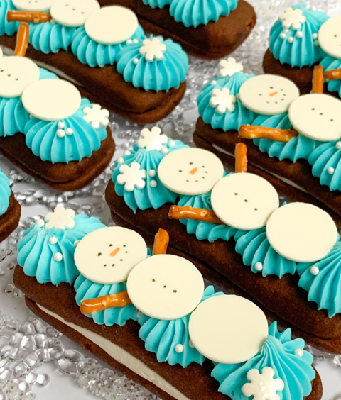 A row of devil dogs topped with blue icing and snowmen