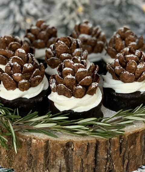 ring dings decorated with a pinecone made from frosting