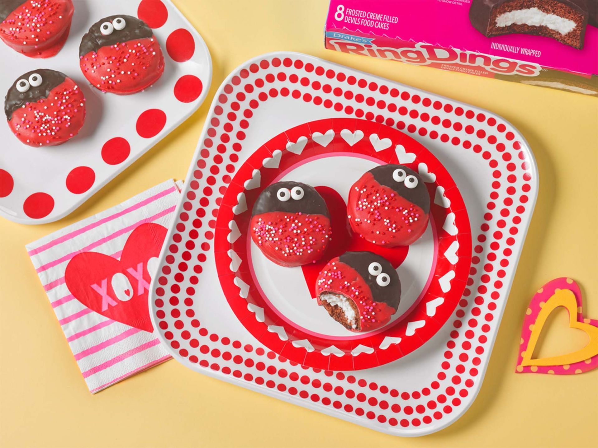 A box of drake 's ring dings is next to a plate of cakes