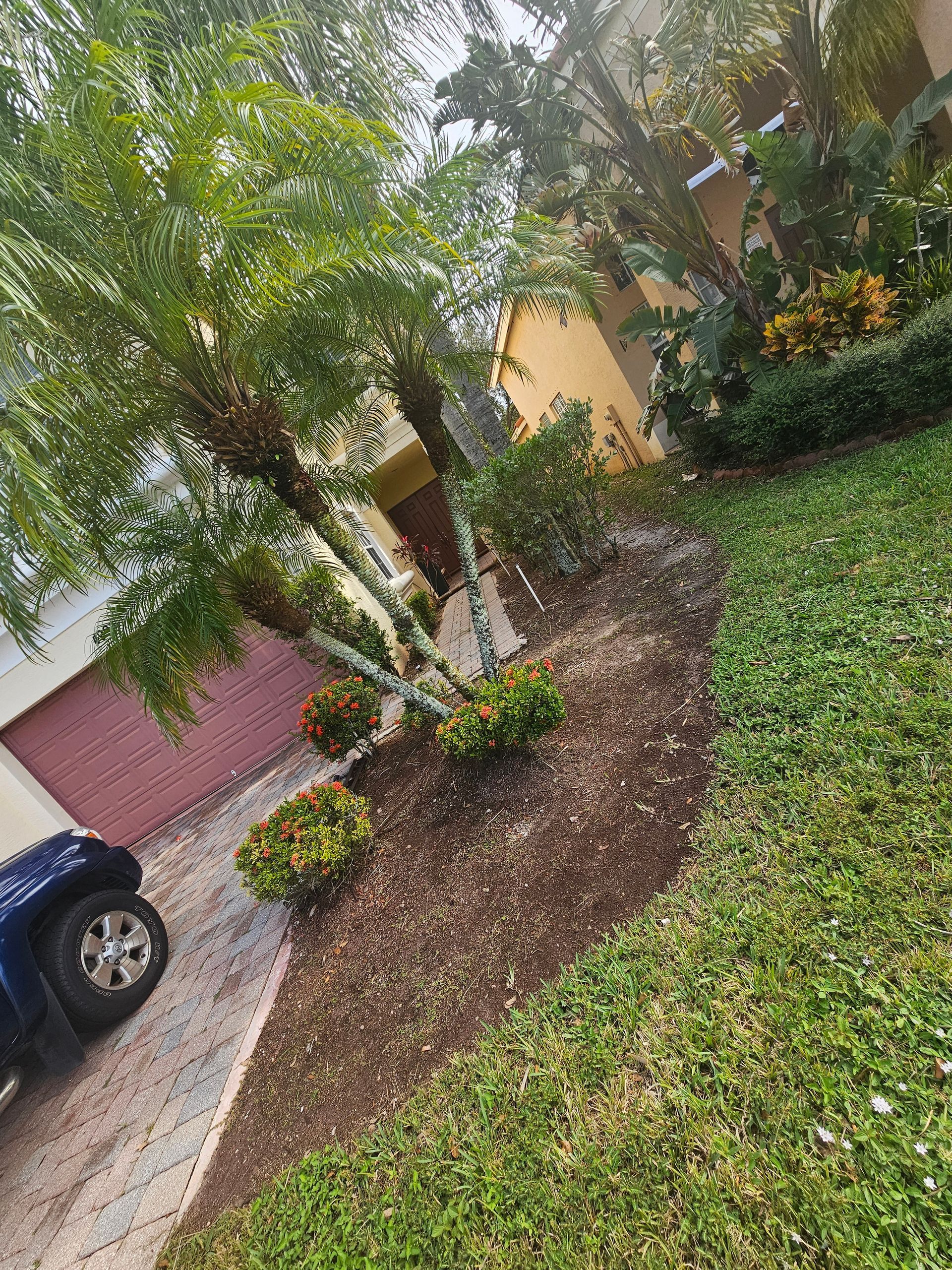 A blue suv is parked in front of a house.