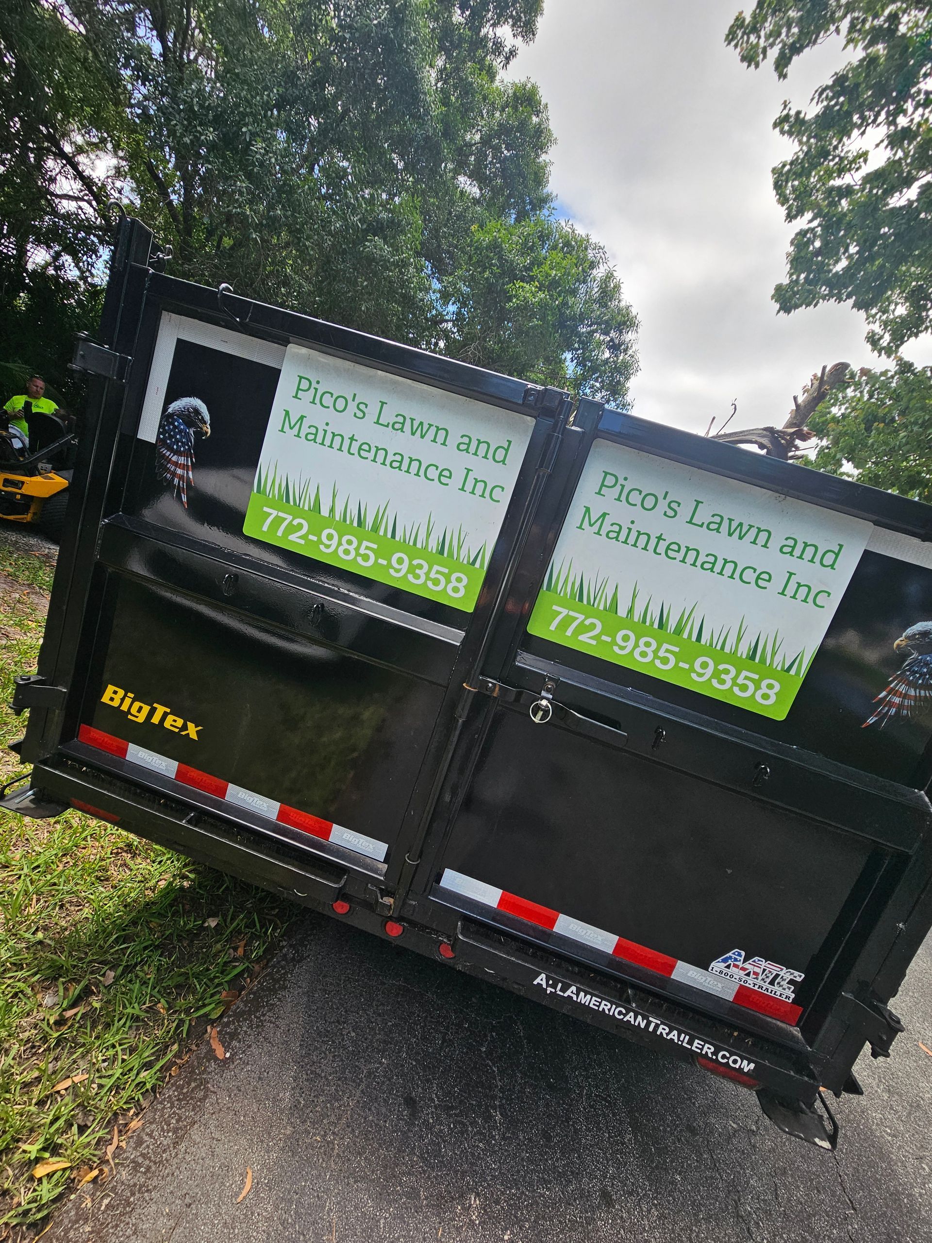 A dumpster is parked on the side of the road.