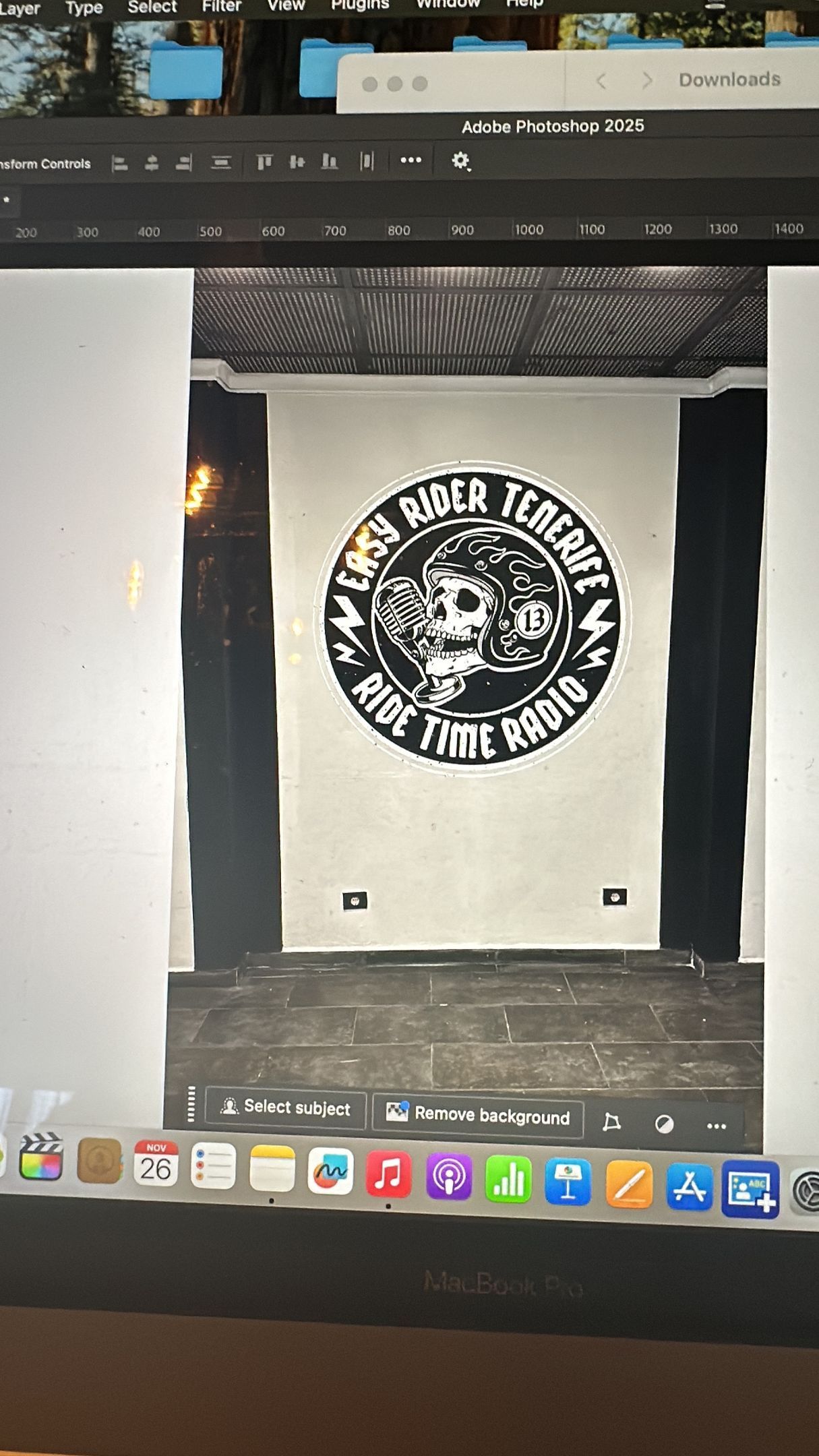 A computer screen shows a picture of a logo on a wall.