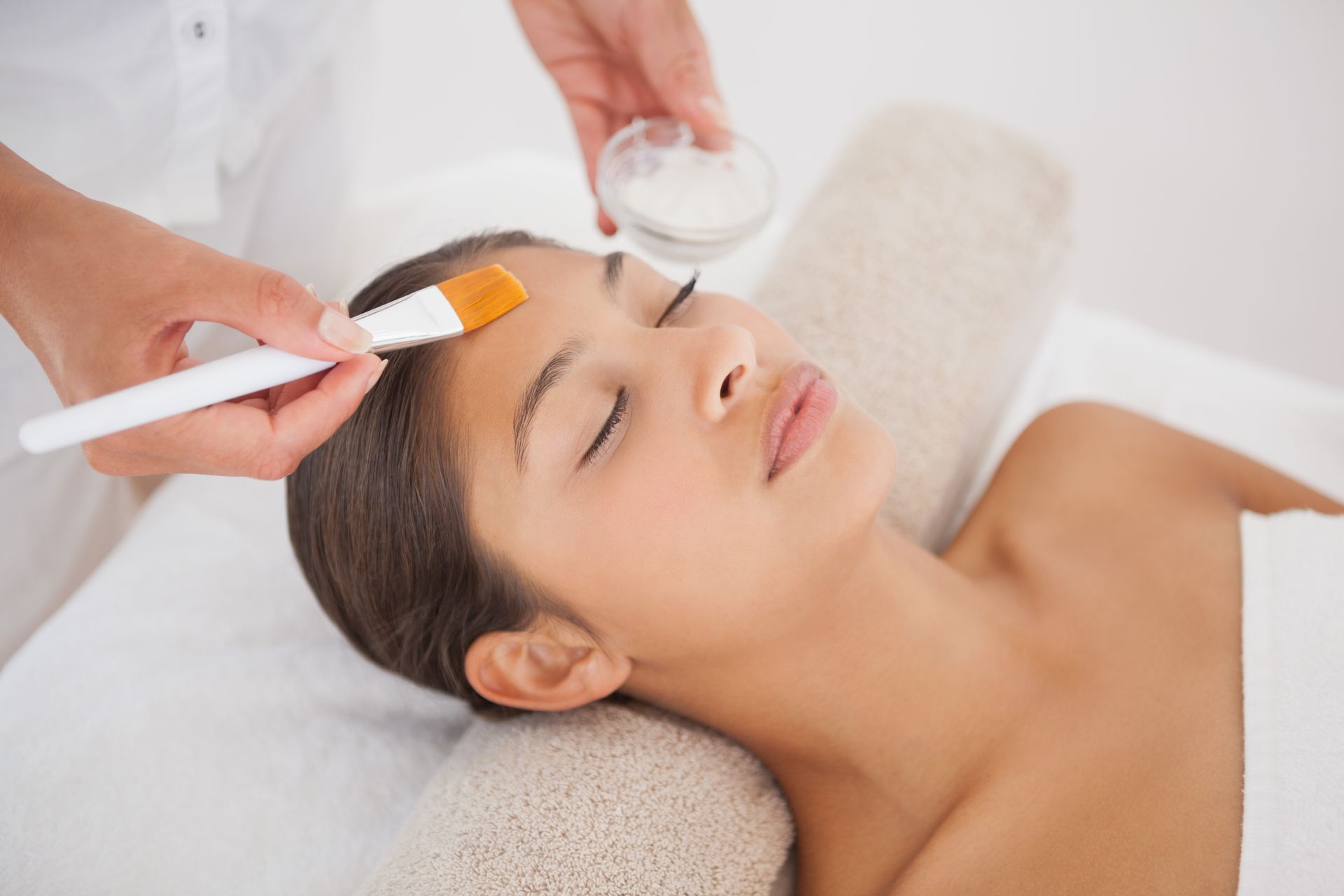 A woman is getting a facial treatment at a spa.