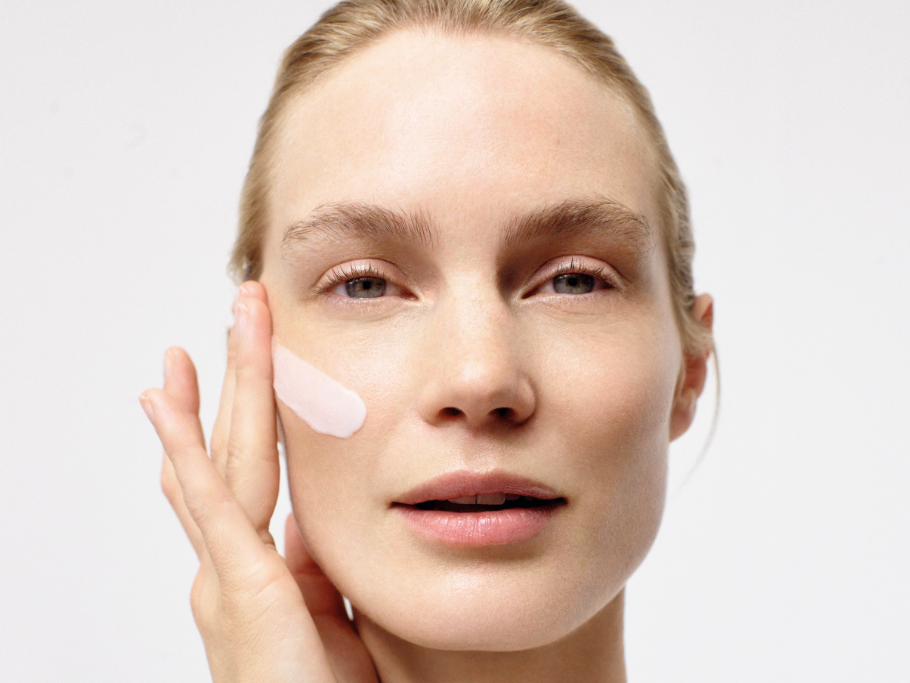 A woman is getting a facial massage at a spa.