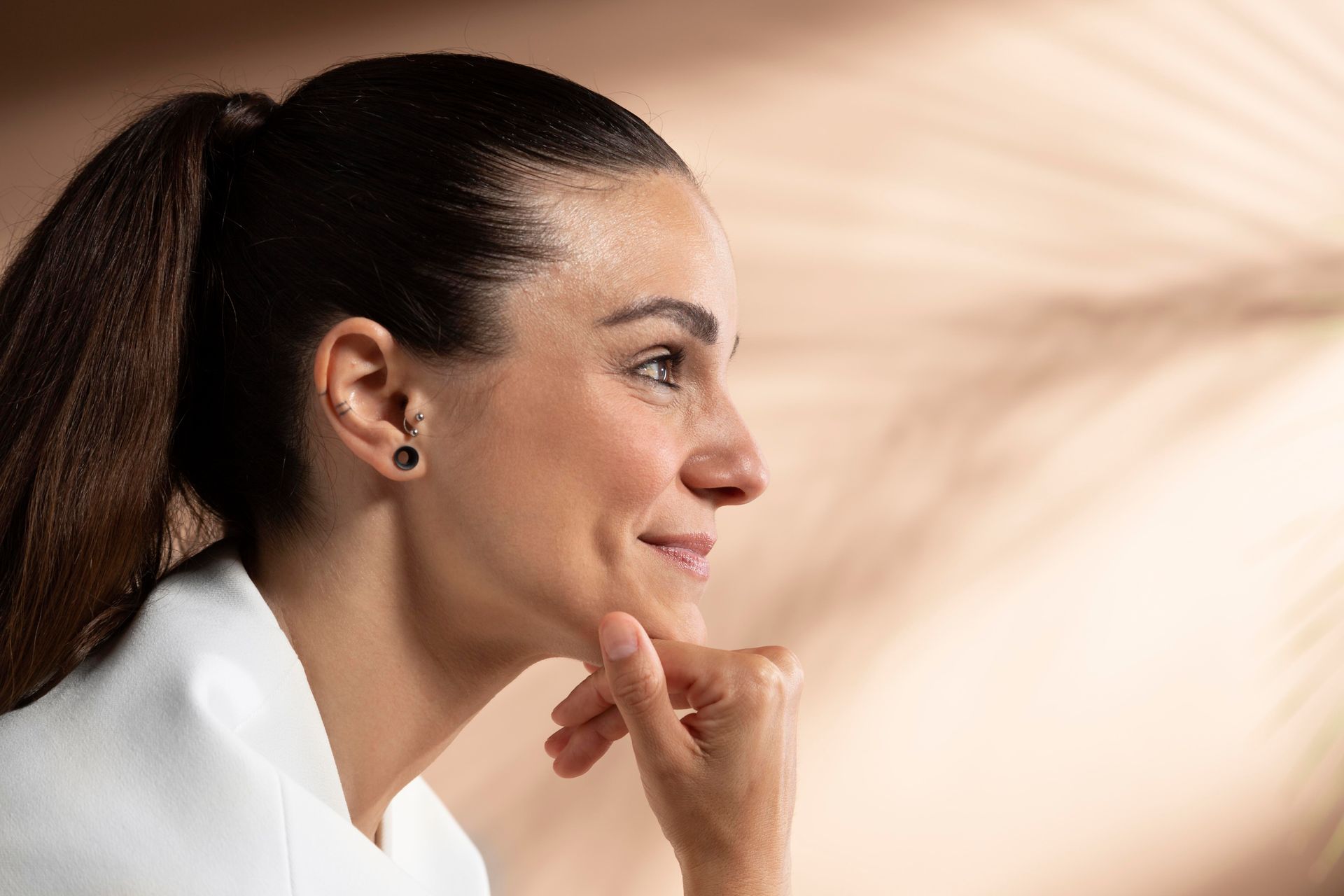 A woman is holding her face with her hands and making a funny face.
