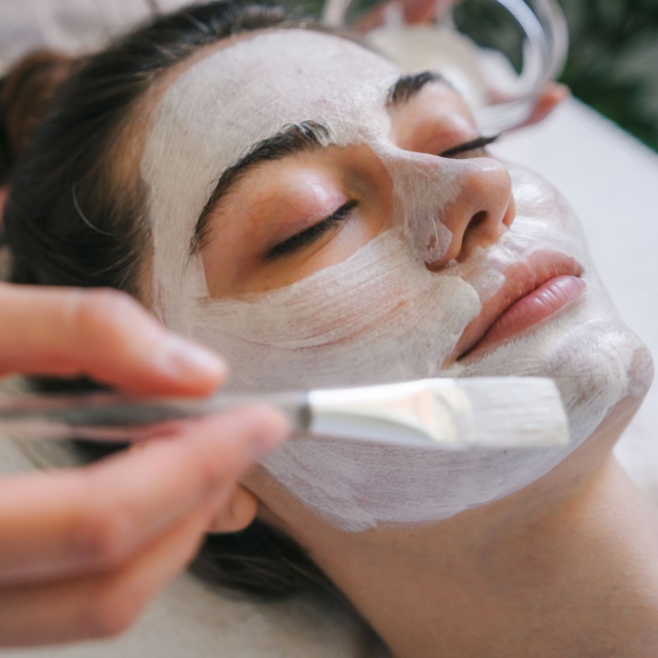 A woman is getting a facial treatment at a spa.