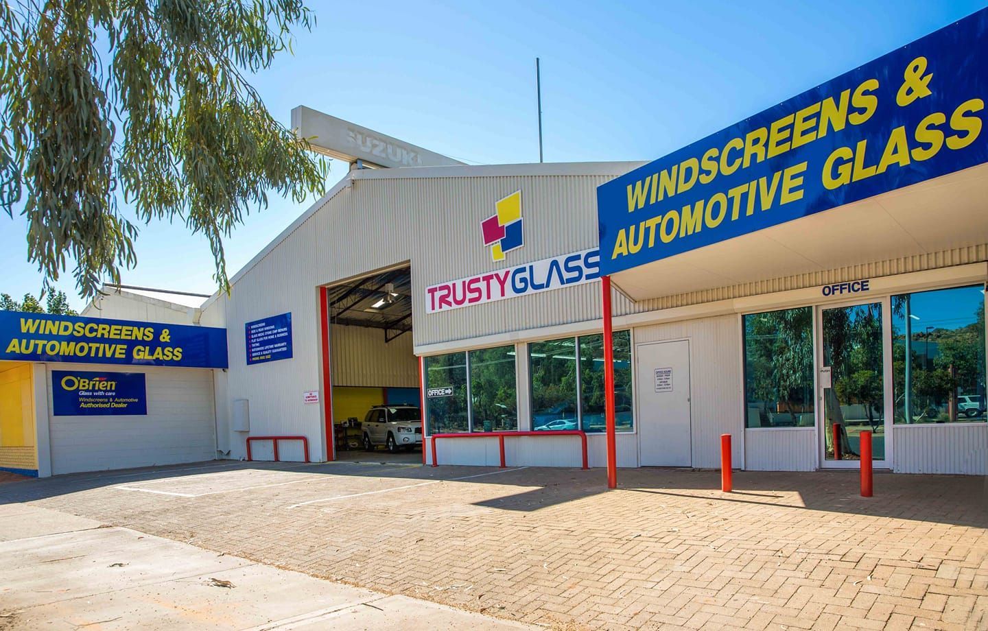 A Building With a Sign That Says Windscreens and Automotive Glass — Trusty Glass In Alice Springs, NT