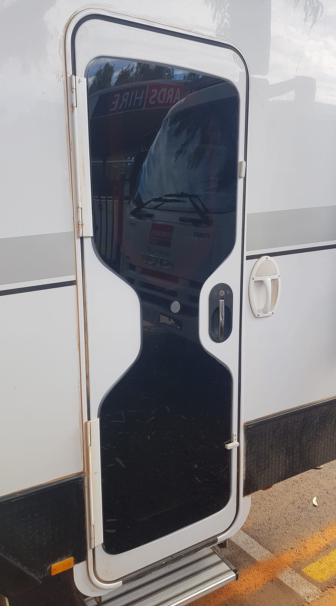 A White Van With a Glass Door is Parked in a Parking Lot — Trusty Glass In Alice Springs, NT