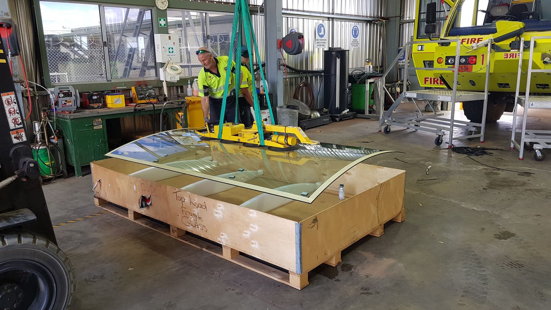 Male Worker Repairing New Glass in Warehouse — Trusty Glass In Alice Springs, NT