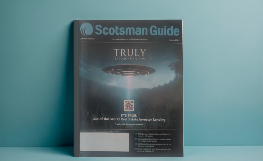 Scotsman Guide magazine with a UFO illustration on the cover, set against a teal background.