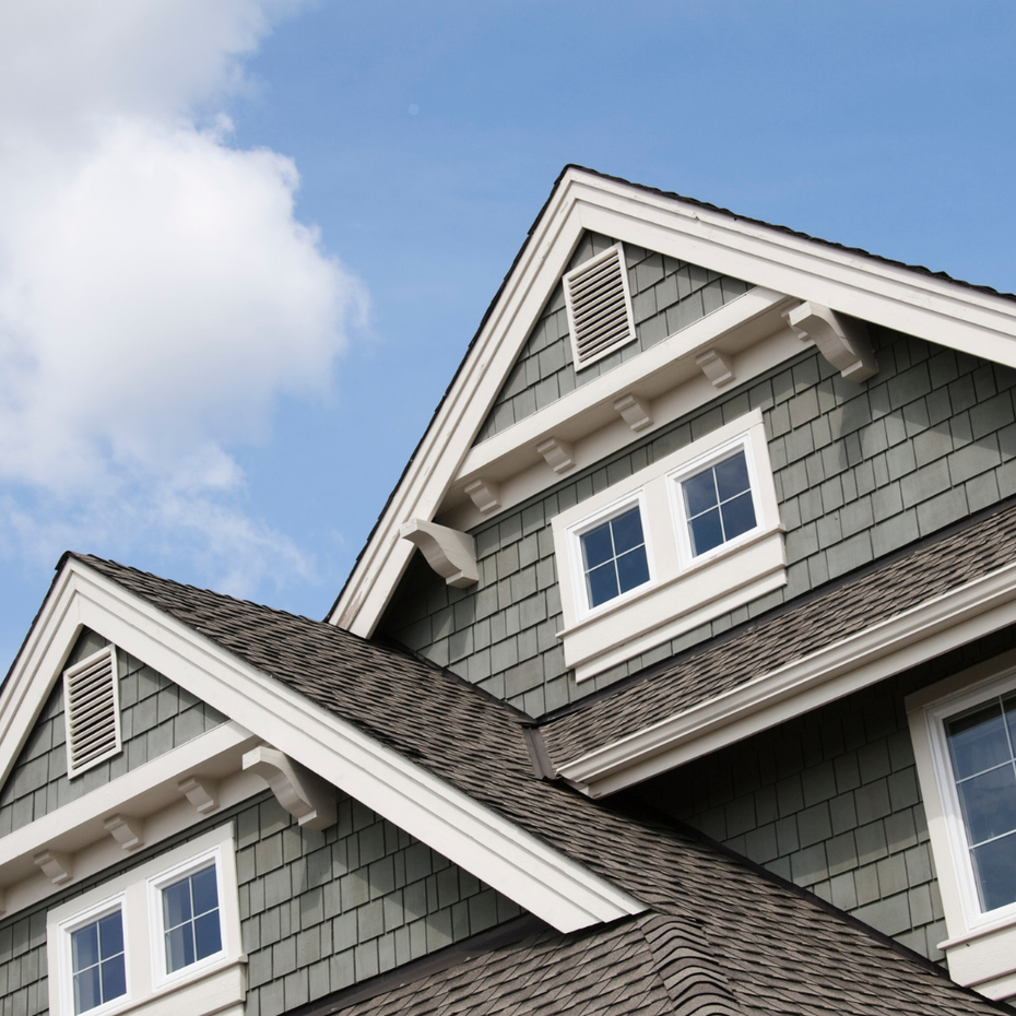 The roof of a house with a blue sky in the background