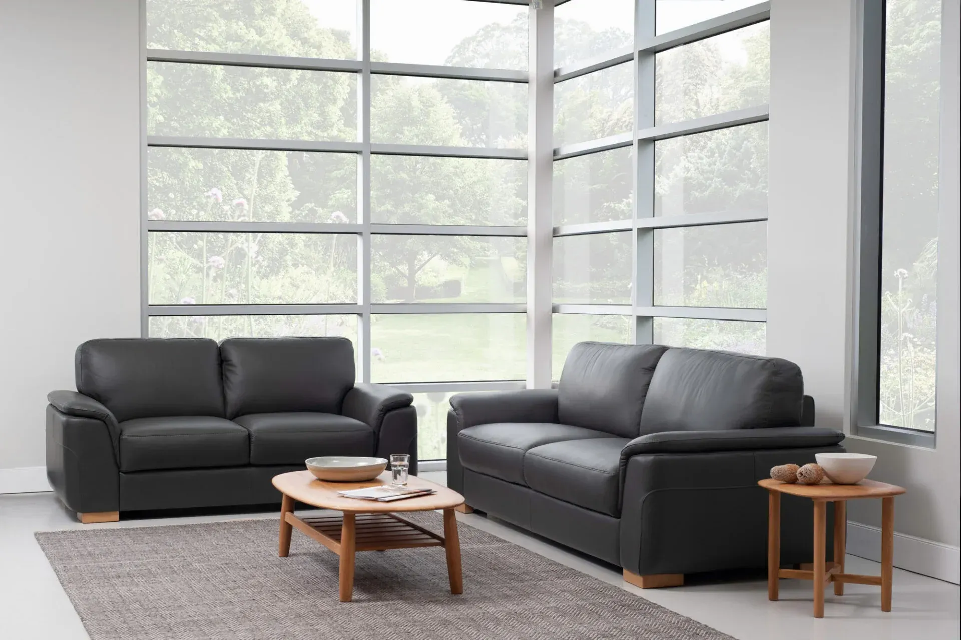 A Black Leather Couch on a White Background — Envisage Furniture in Kialla, VIC