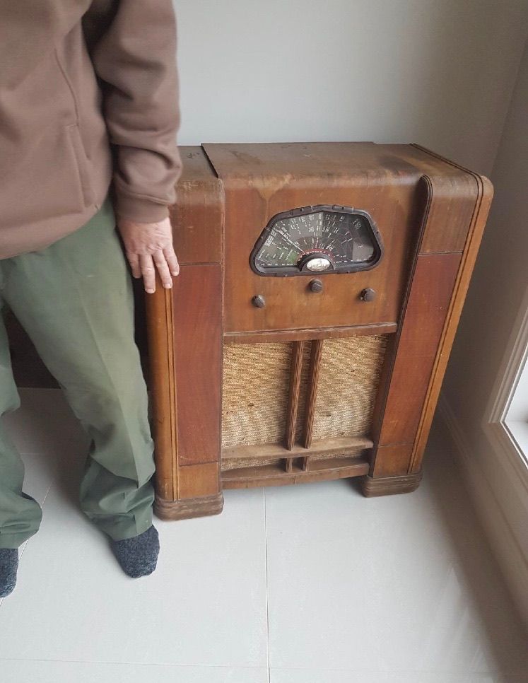 A Person Is Standing Next To An Old Wooden Radio — Envisage Furniture in Kialla, VIC