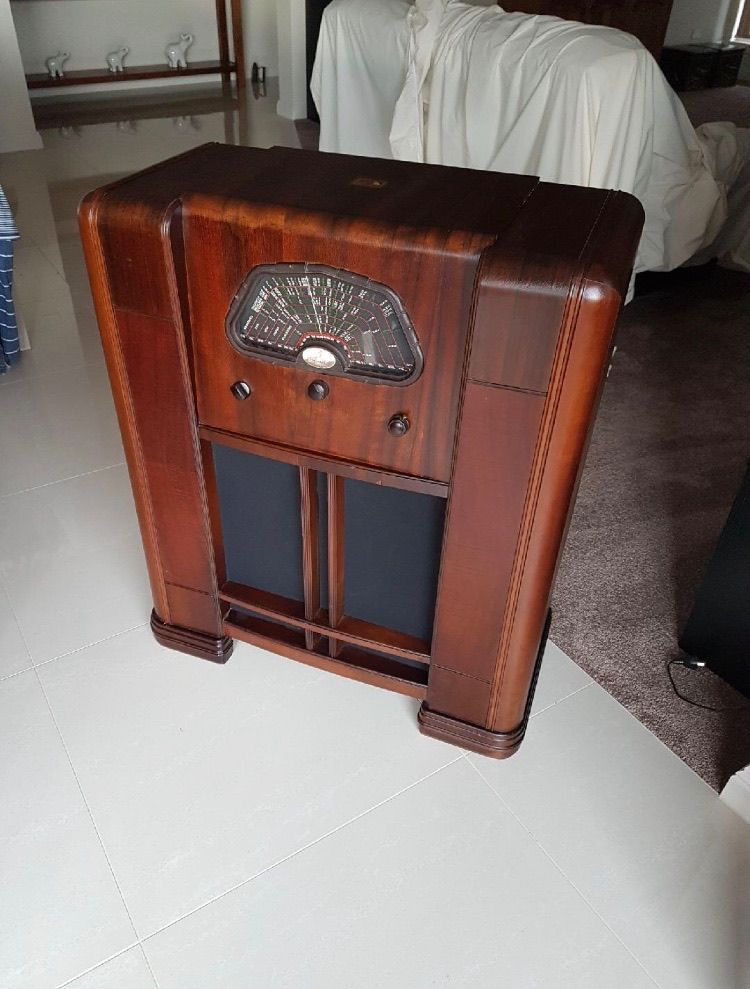 A Wooden Radio Is Sitting On The Floor In A Living Room — Envisage Furniture in Kialla, VIC