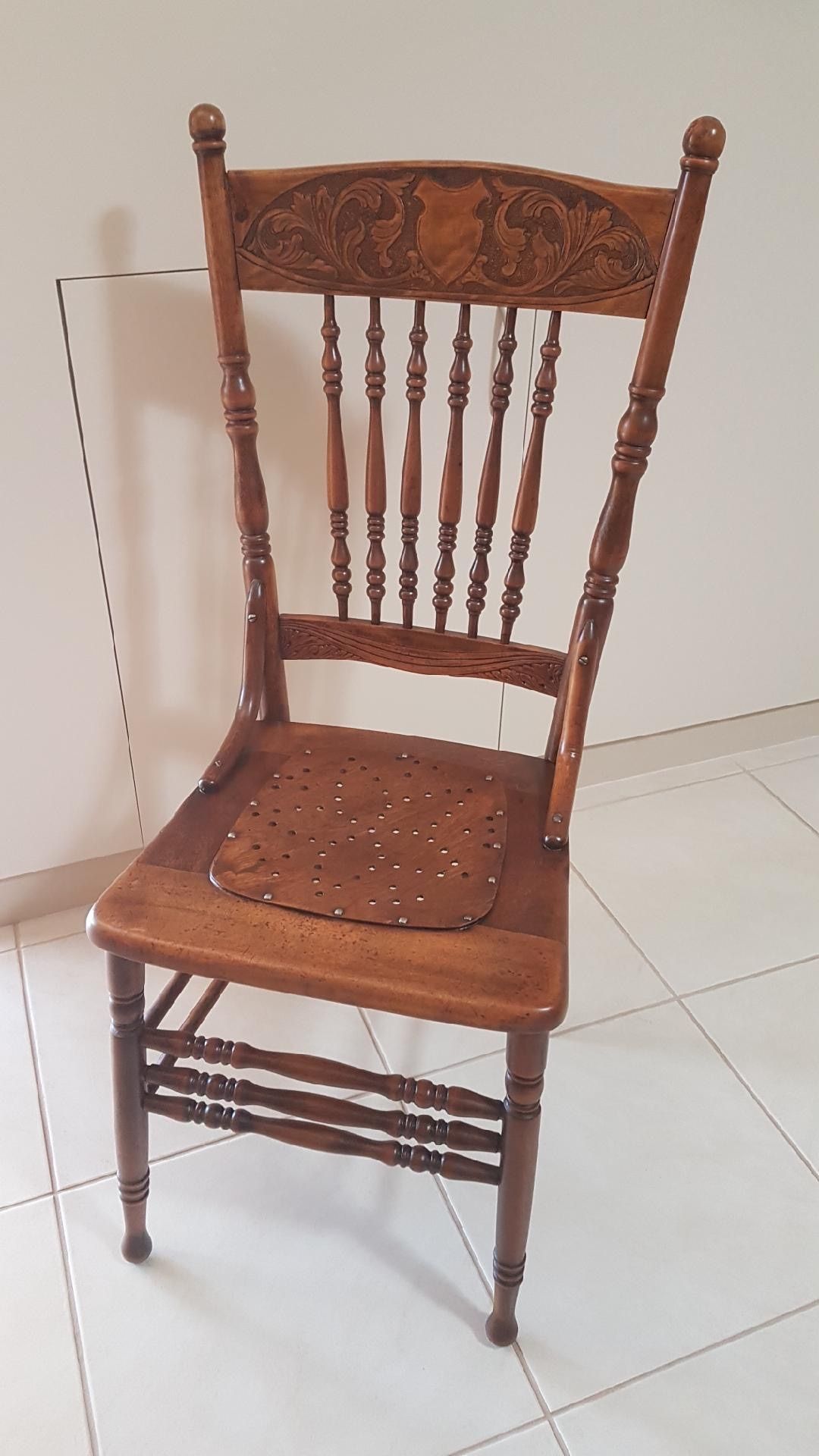 A Wooden Chair Is Sitting On A Tiled Floor In A Room — Envisage Furniture in Kialla, VIC