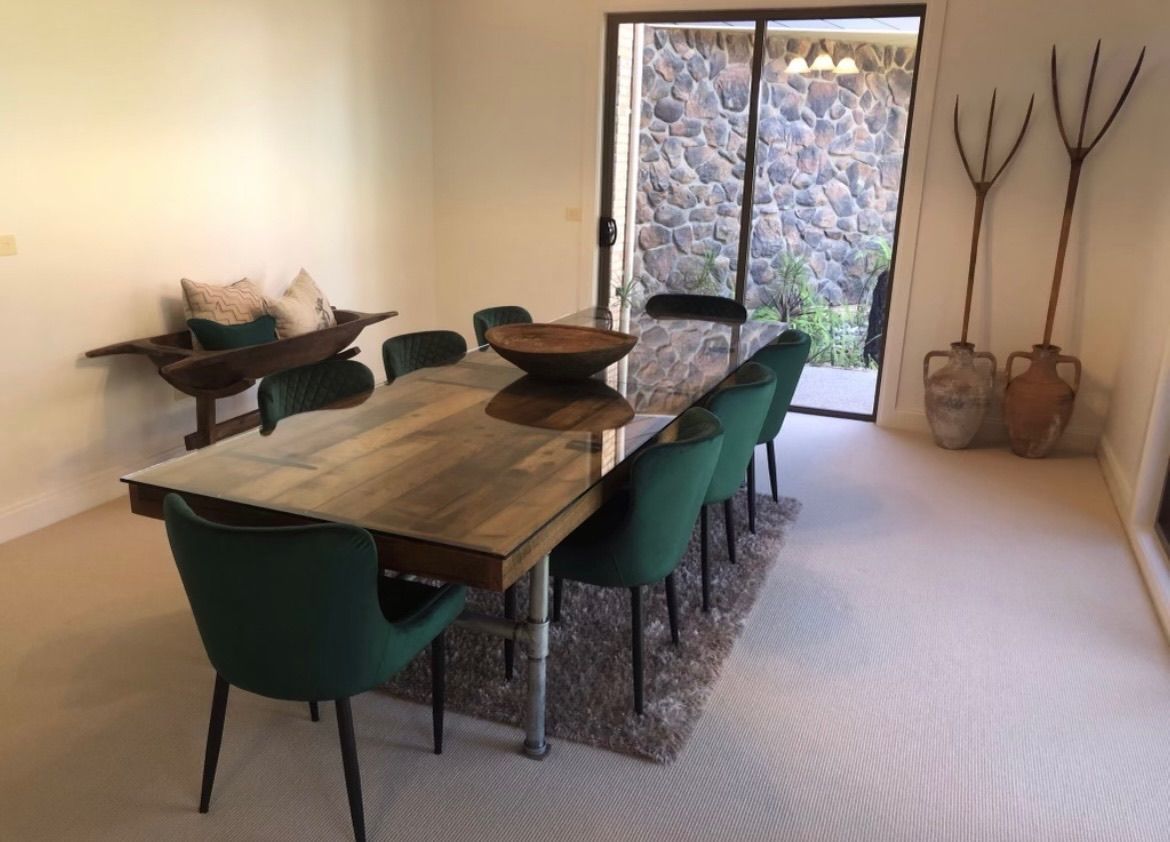 A Dining Room With A Wooden Table And Green Chairs — Envisage Furniture in Kialla, VIC