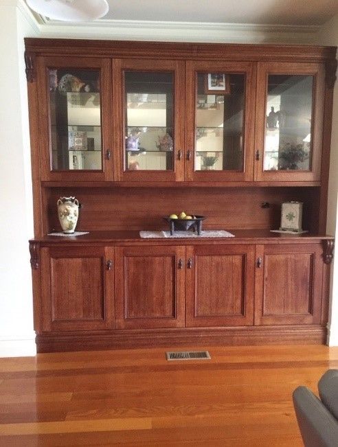 A Living Room With A Large Wooden Cabinet With Glass Doors — Envisage Furniture in Kialla, VIC