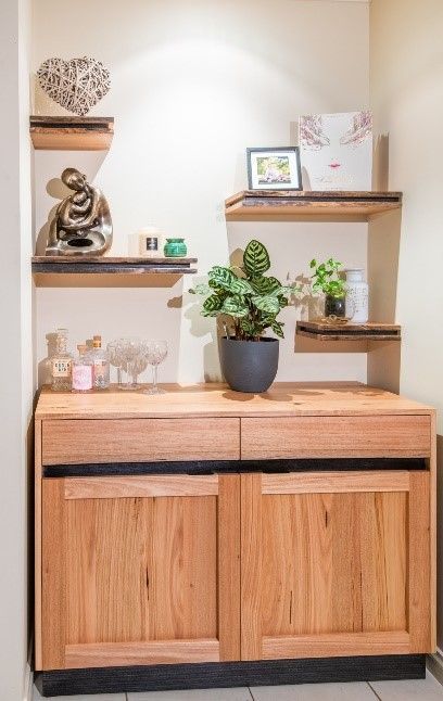 A Wooden Cabinet With A Potted Plant On Top Of It — Envisage Furniture in Kialla, VIC