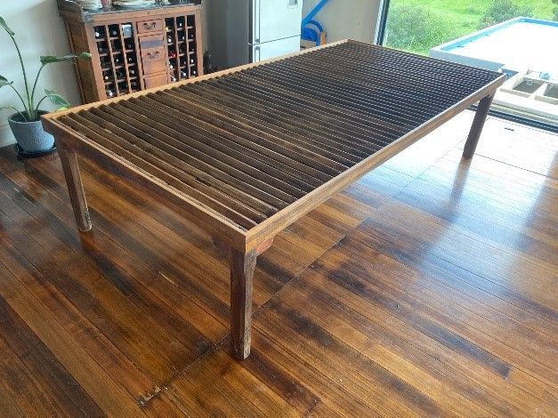 A Wooden Table Is Sitting On A Wooden Floor In A Living Room — Envisage Furniture in Kialla, VIC