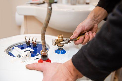 Worker Fixing Boiler Tubes — Odessa, TX — Stephen's Plumbing Heating & Air Conditioning