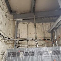 A room with a lot of wires hanging from the ceiling.