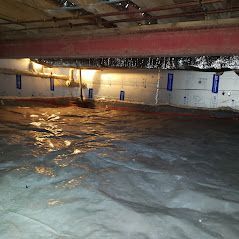 A flooded basement with a lot of water coming out of it.
