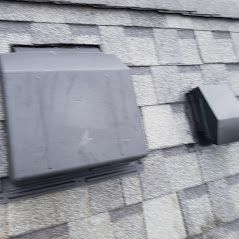 A close up of a roof with a vent on it.