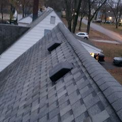 A roof of a house with a car parked on the side of it.