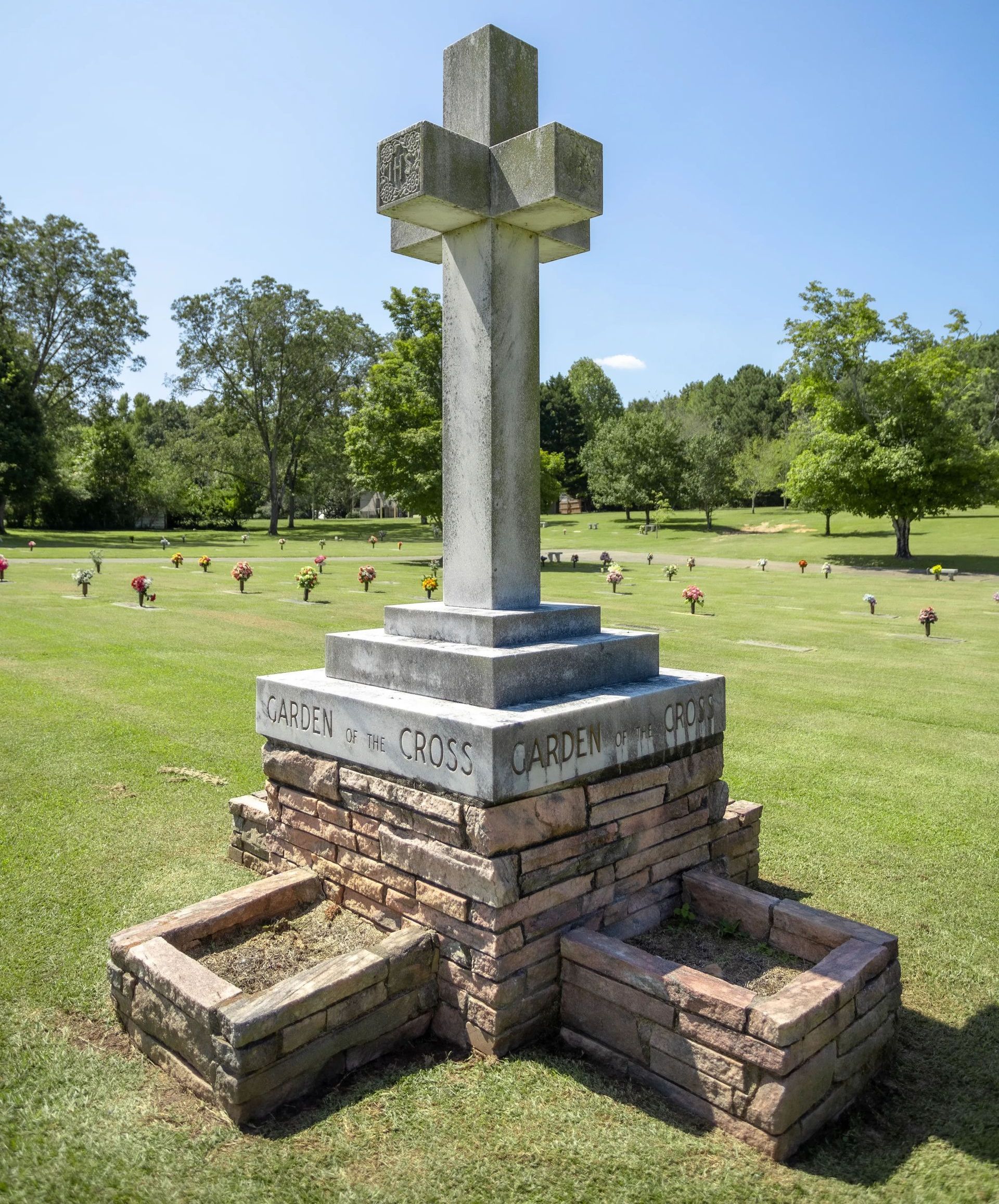 A graveyard with a cross in the middle of it