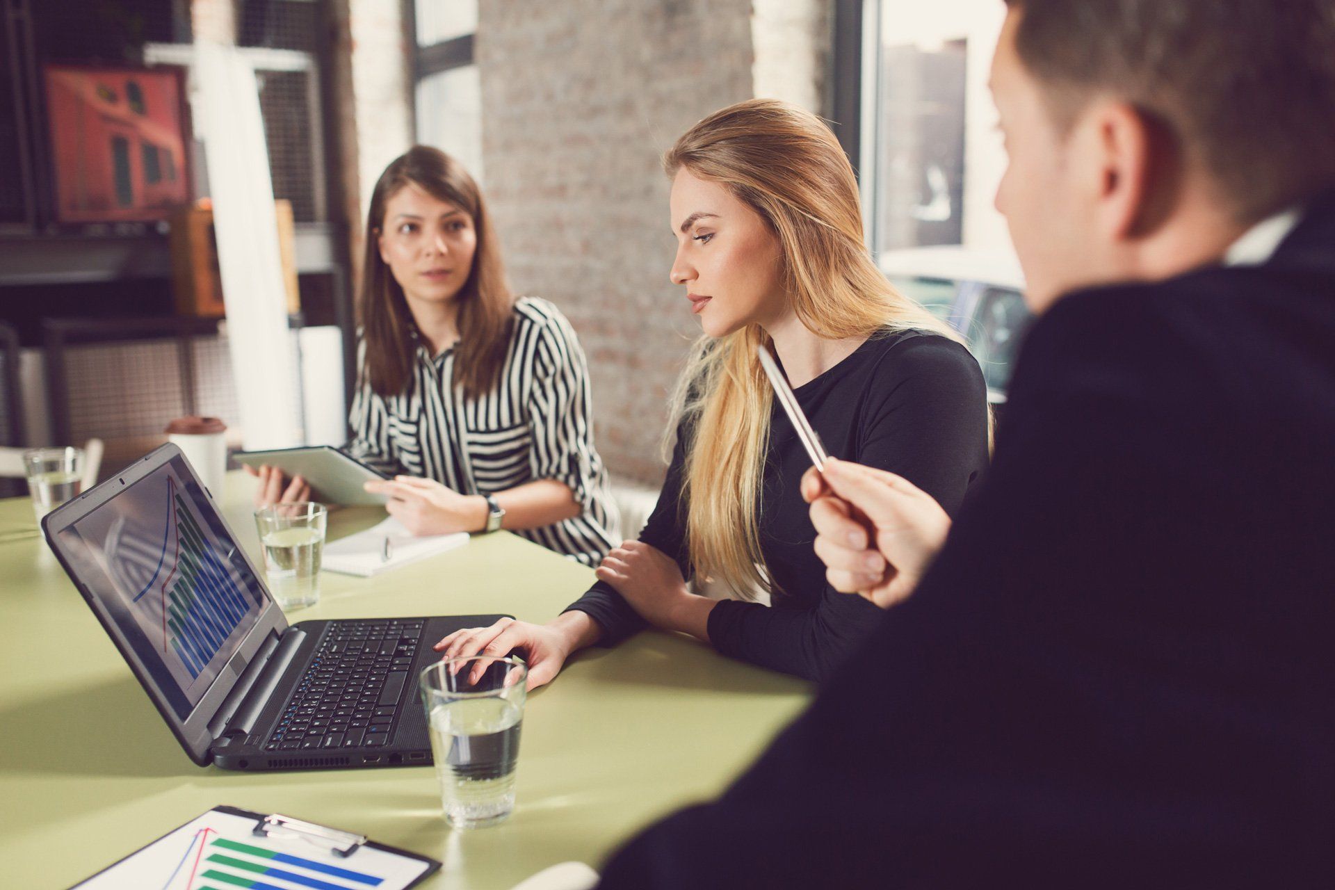 A three-person discussing a business in the front of a computer | Melbourne, VIC | Menzies Advisory