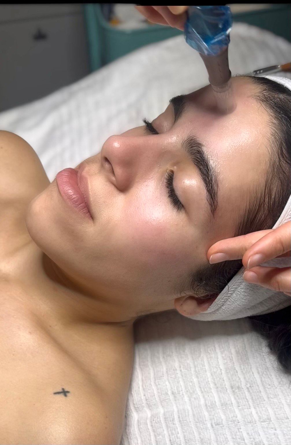 Several boxes of dermalogica products are lined up on a wooden shelf