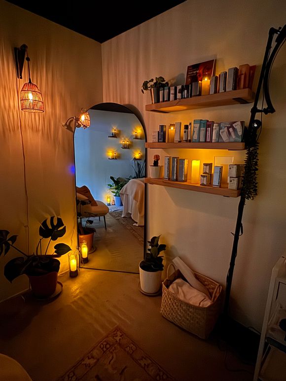 A woman is laying on a bed with a magazine on top of her.