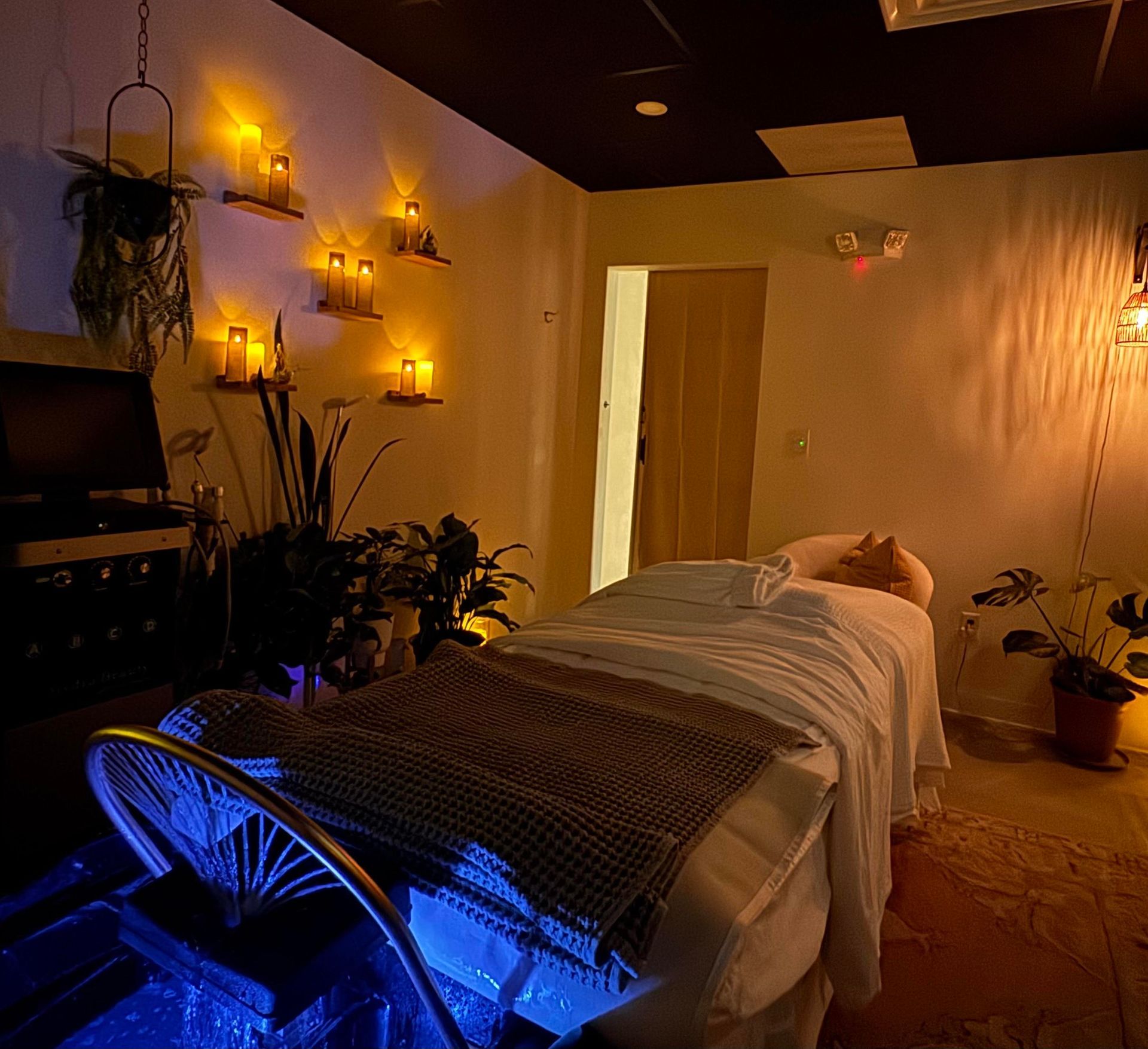 Three candles are sitting on wooden shelves on a wall