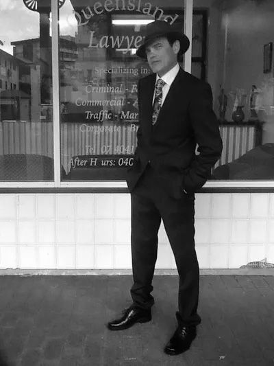 A Man And A Woman Are Sitting At A Table — Cairns Criminal Lawyers In Cairns City, QLD