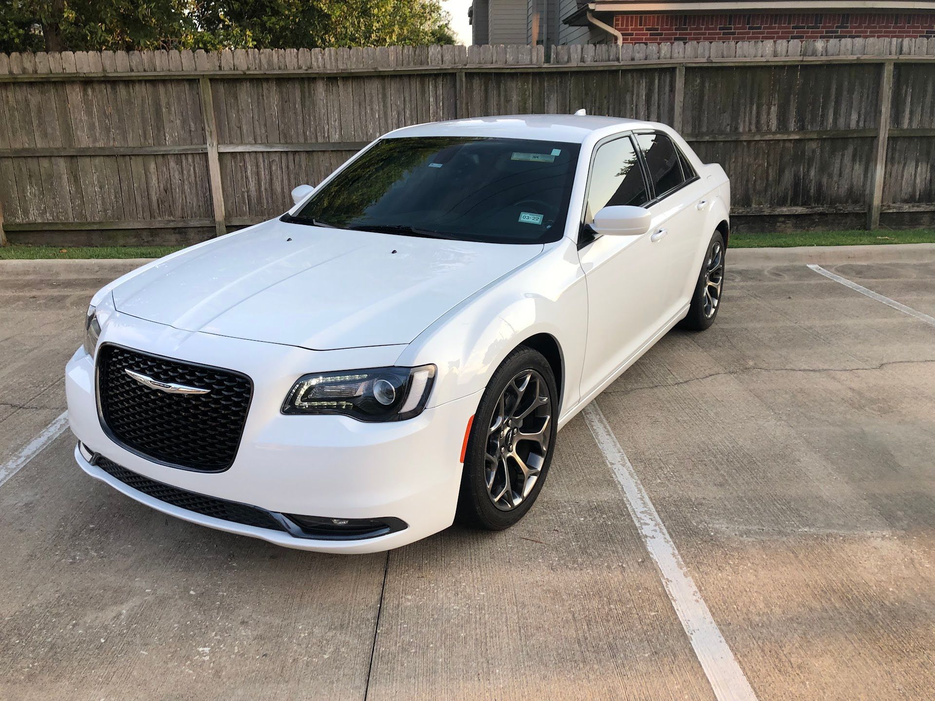 White Chrysler 300 sedan parked in a parking lot, facing the camera. | Meyerland Service Station