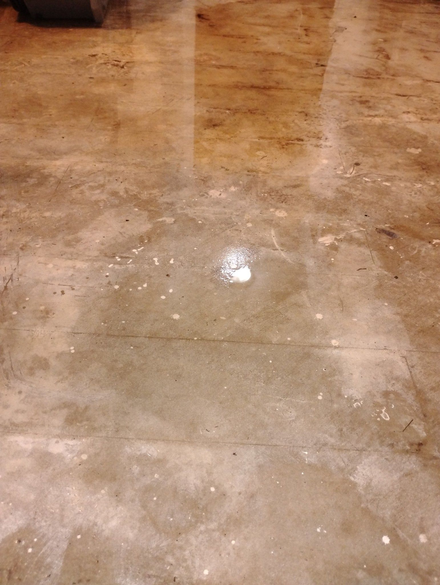 A close up of a marble floor with a reflection of a light.