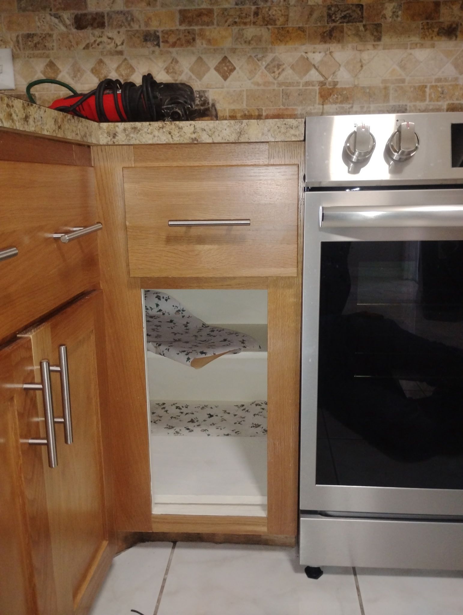 A kitchen with stainless steel appliances and wooden cabinets