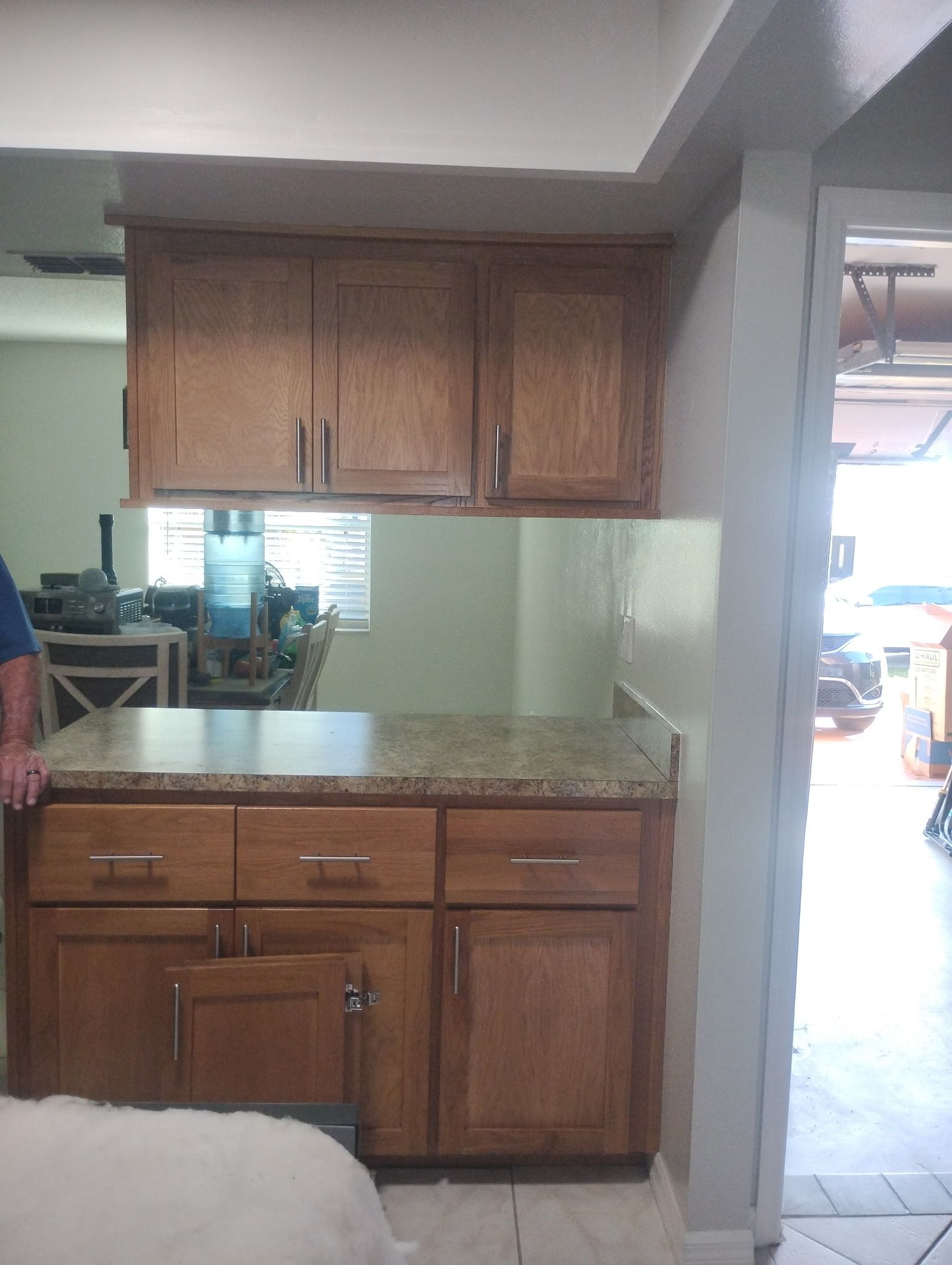 A kitchen with wooden cabinets and granite counter tops