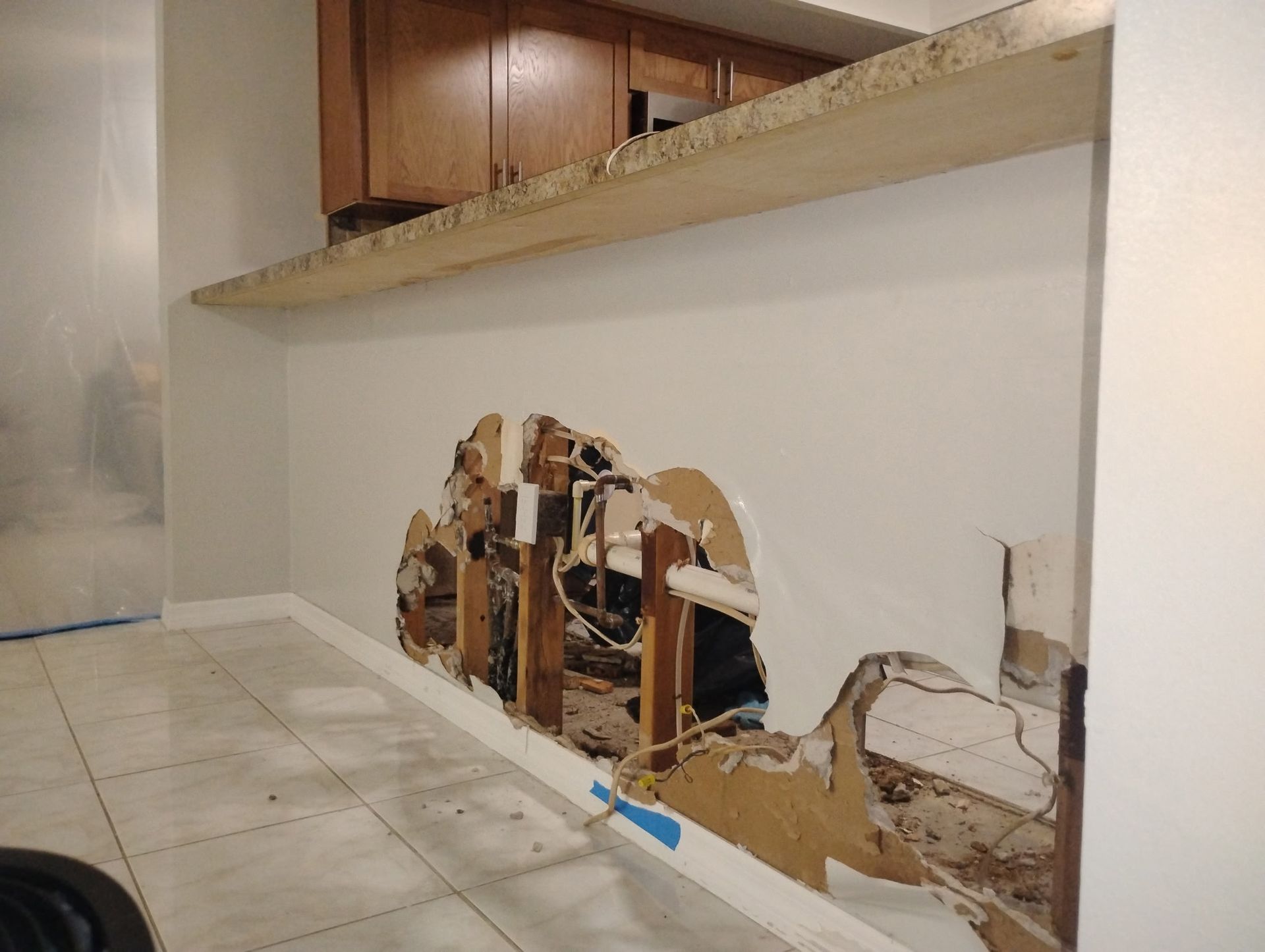 There is a hole in the wall in the kitchen.