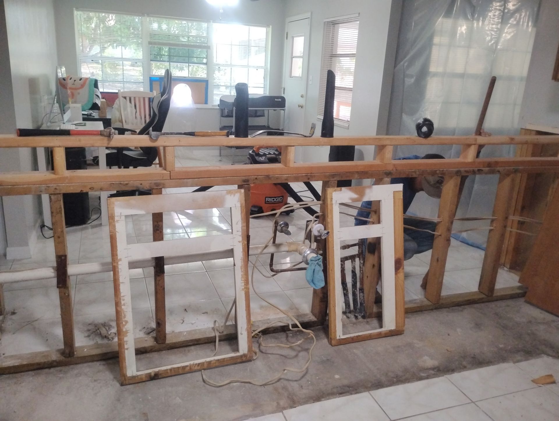 A room with a lot of wooden frames on the floor.