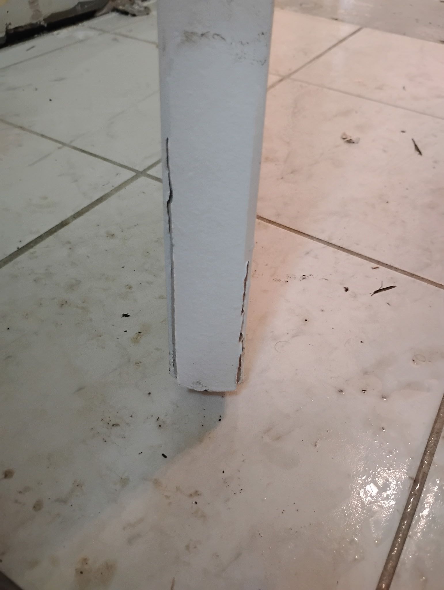 White rectangular object on tiled floor.