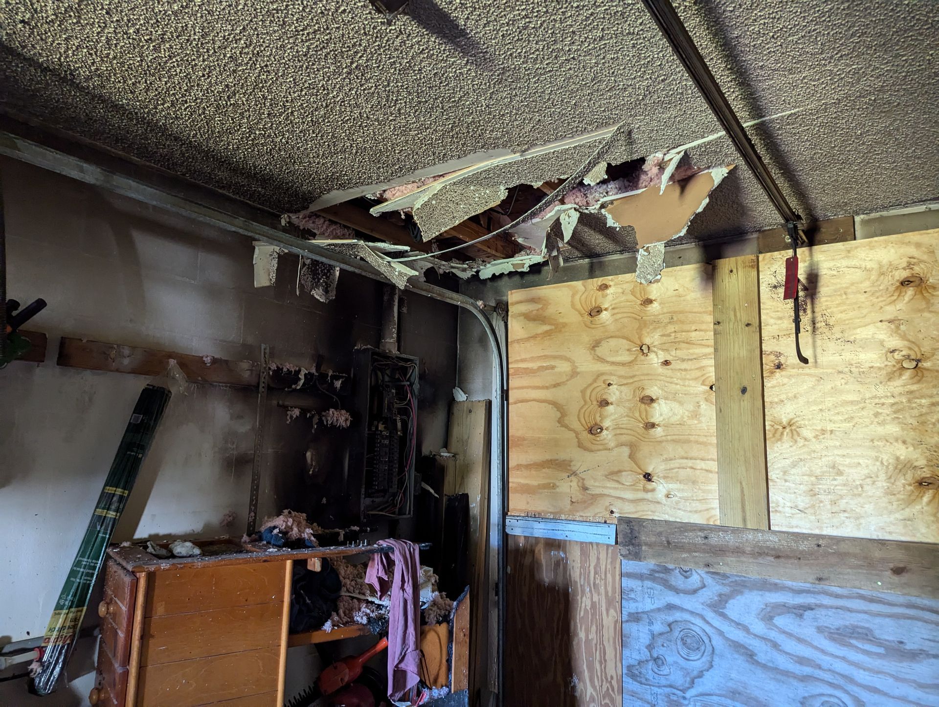 A room with a ceiling that has been damaged by a fire.