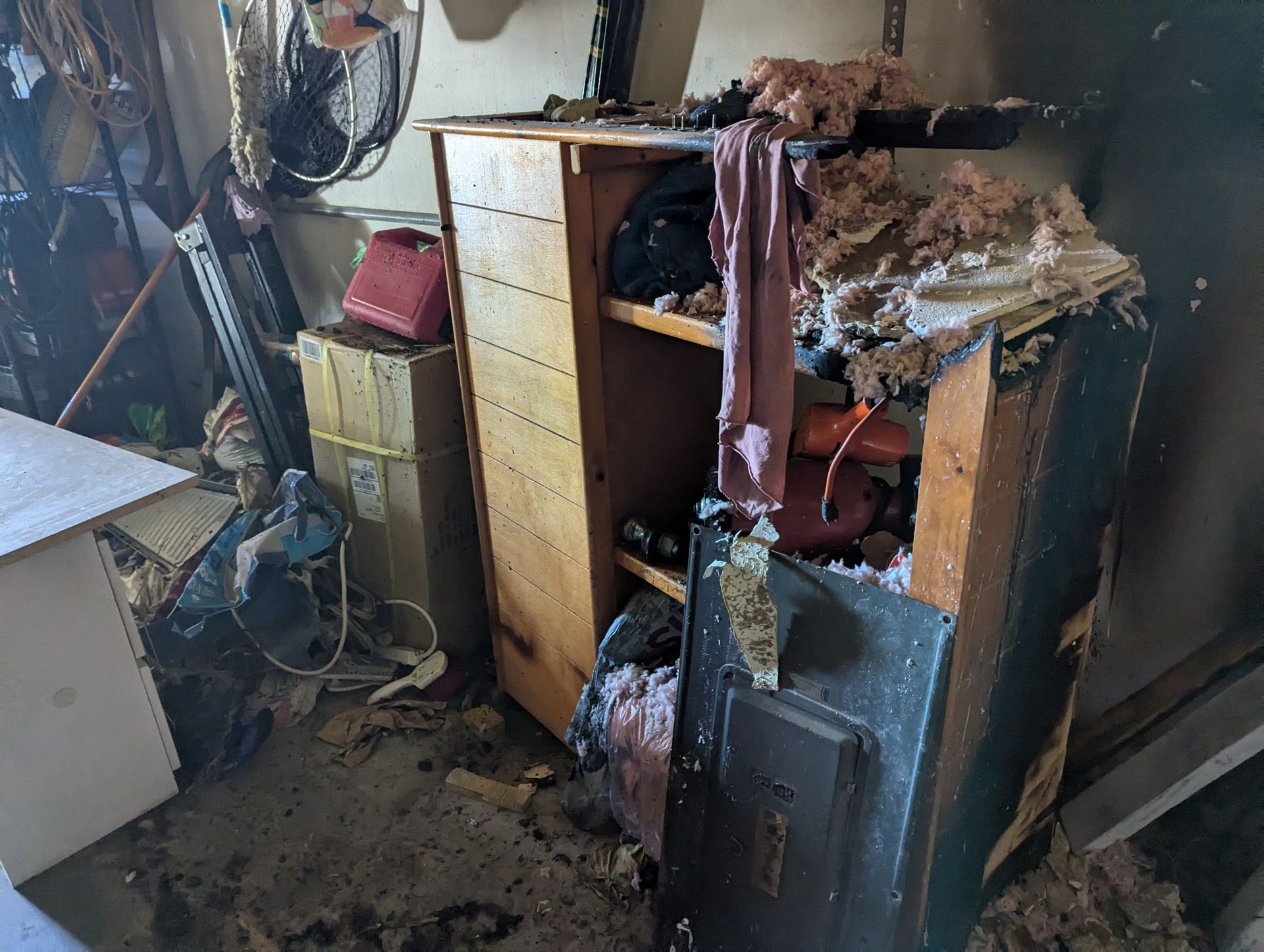 A room filled with lots of furniture and a safe.