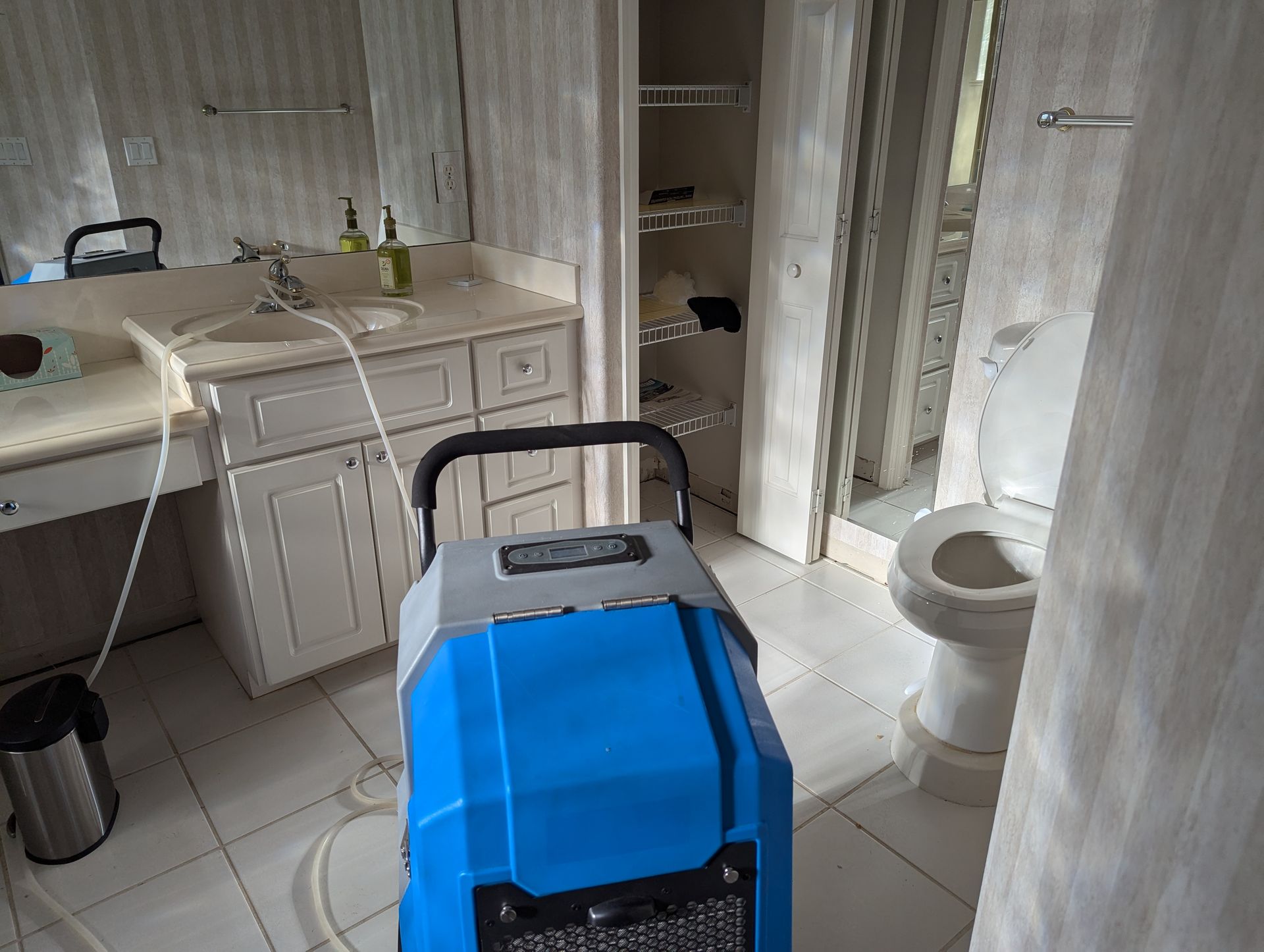 A bathroom with a sink , toilet , and mirror.