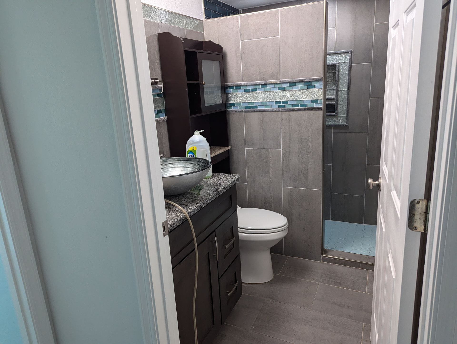 A bathroom with a toilet a sink and a shower