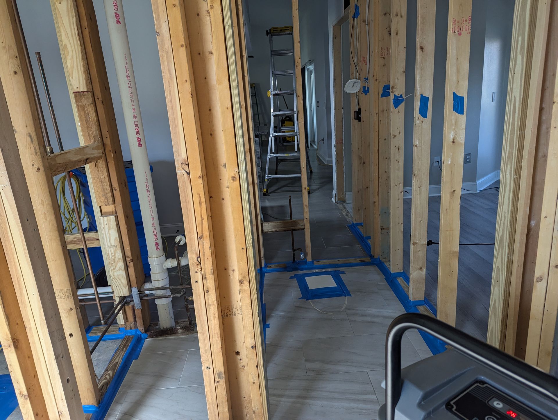 A treadmill is sitting in the middle of a room with wooden beams.