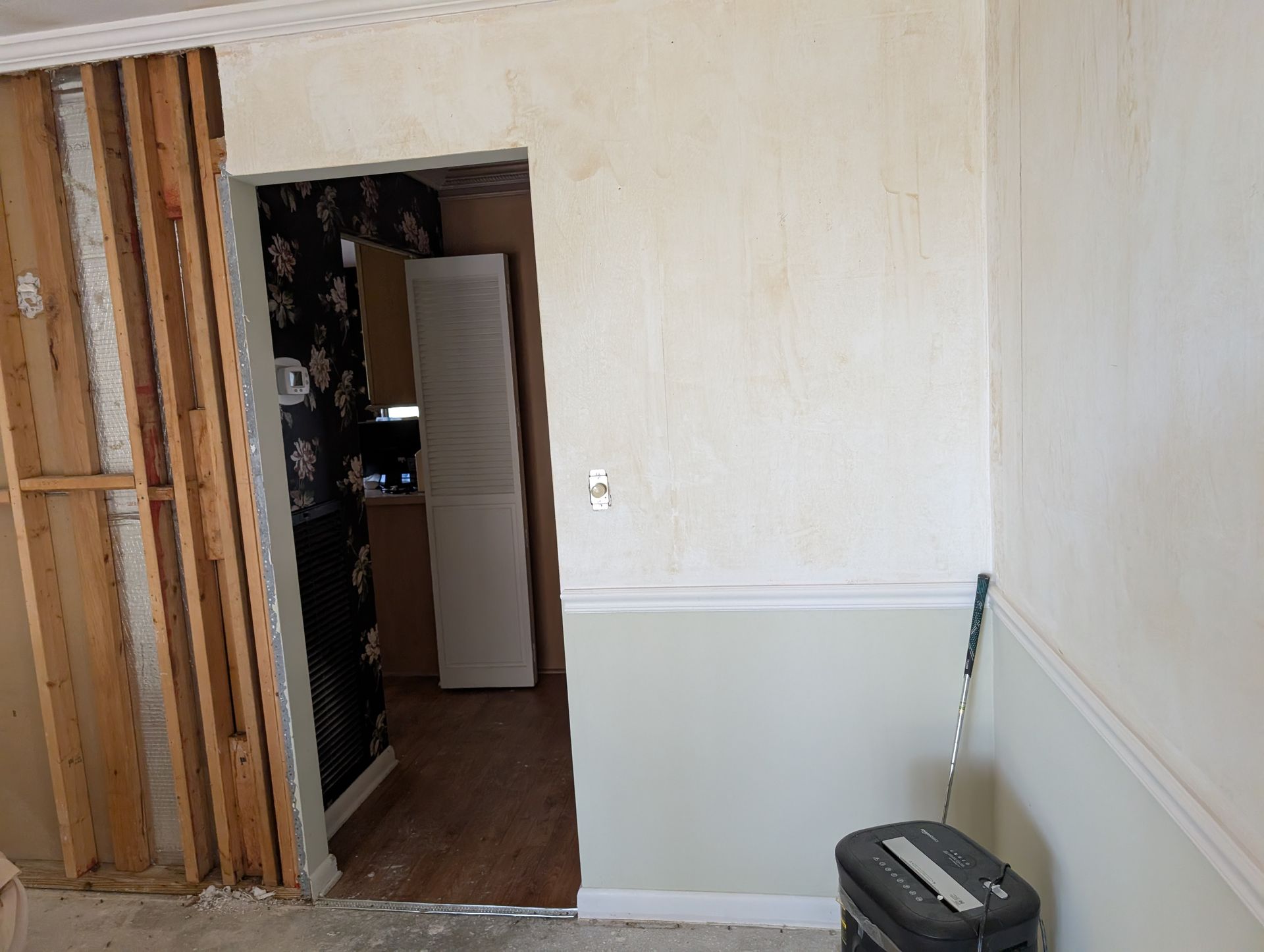 Wall with doorway and partially removed wall. One side of the wall is open to the framing.