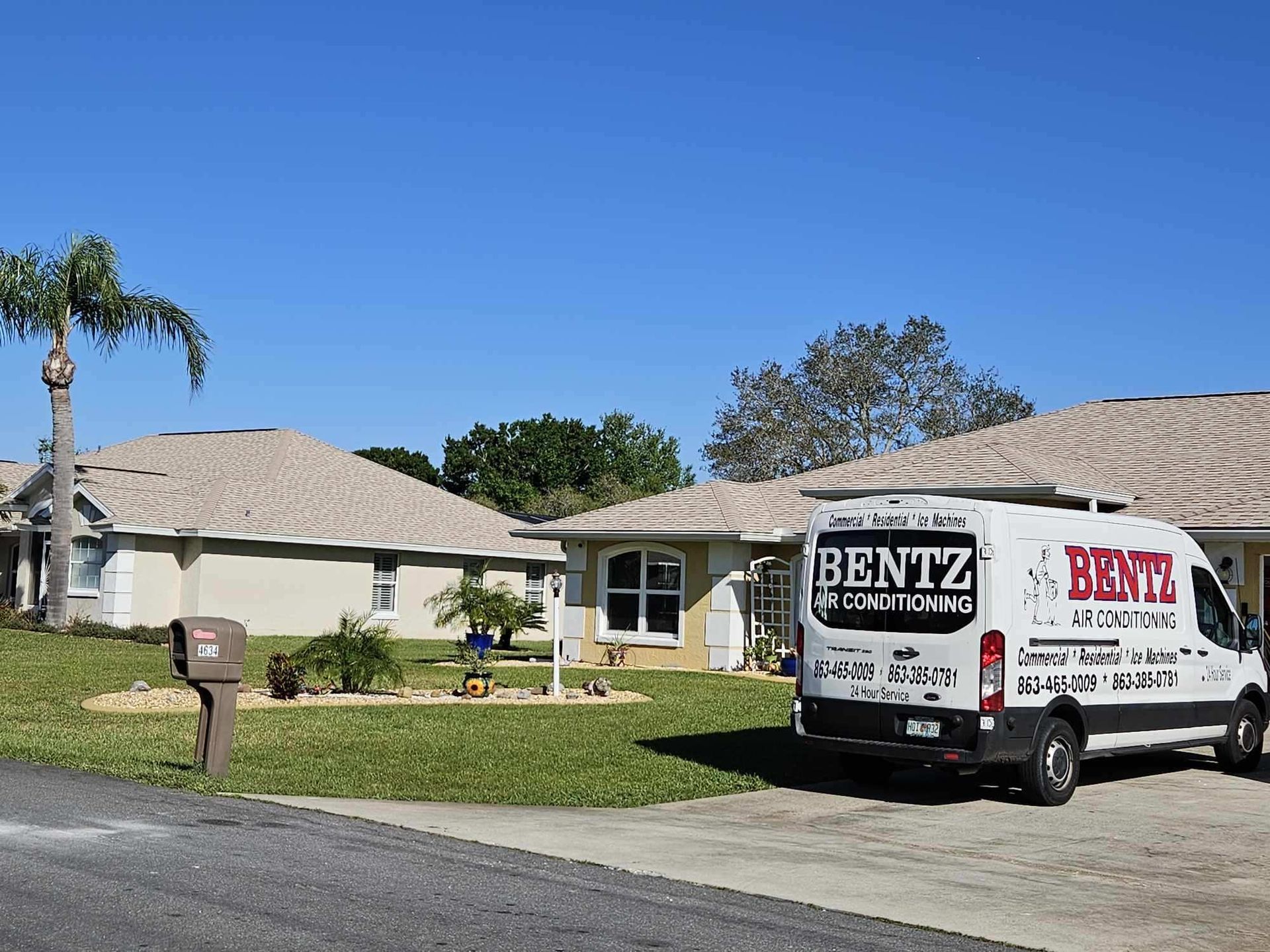 A bentz van is parked in front of a house
